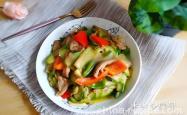 The method of stir frying pork slices with green and red peppers and zucchini