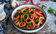 The recipe for stir frying squid rolls with double peppers