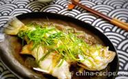 Making Cantonese style steamed sea bass