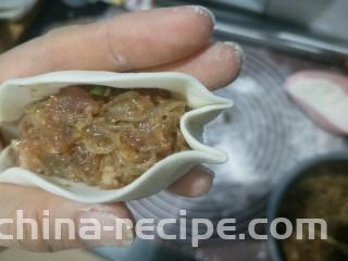 肉沫粉丝包,左手拖住。右手在顶端往里戳进去一点，然后捏住。