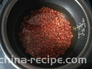 红豆芋圆,红豆放入电饭煲放入浸过红豆的水按下煮饭键煮。