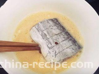 糖醋带鱼,腌渍好的带鱼段，两面沾匀蛋液。