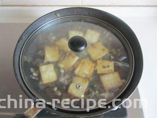 雪菜肉末烧豆腐,加入适量的酱油和水， 煮上一、两分钟；