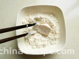 脆皮杏鲍菇,取一块杏鲍菇，均匀沾满面粉。