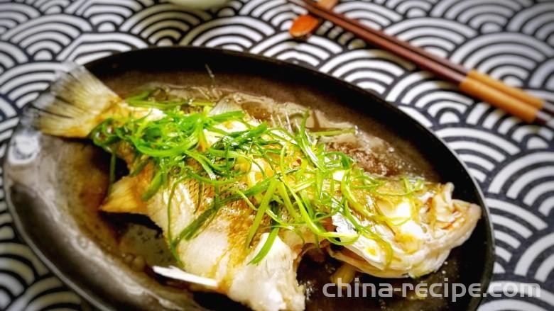 Making Cantonese style steamed sea bass